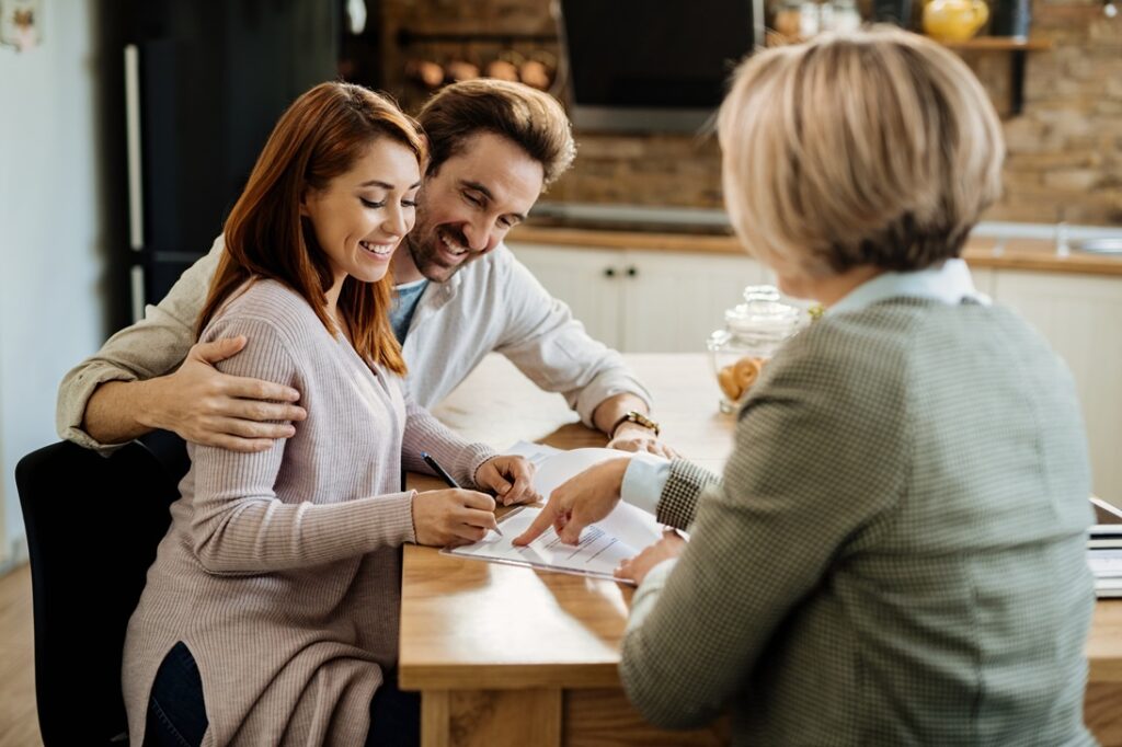 couple-signing-documents-in-a-home-environment